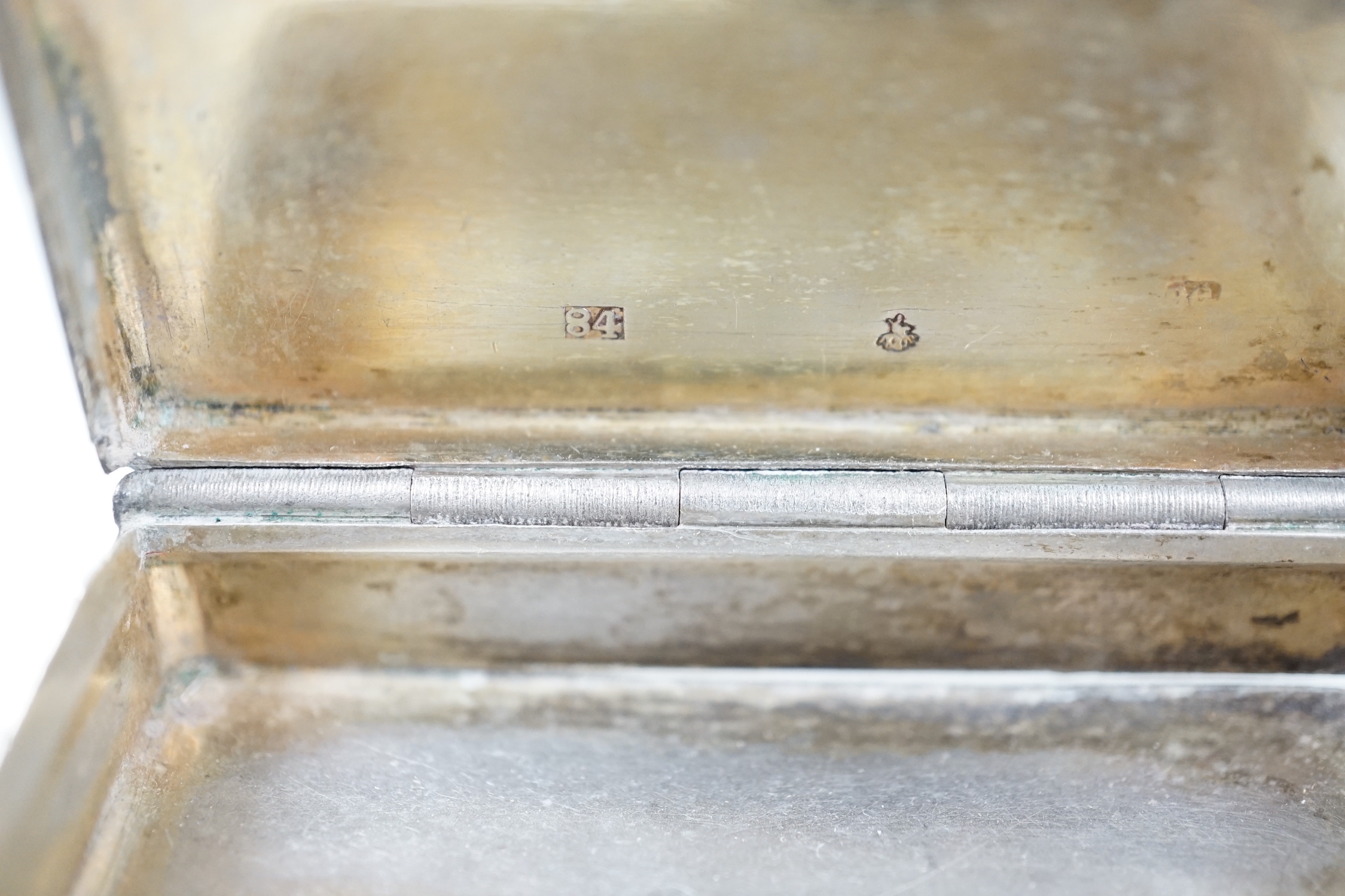 A white metal cigarette case, with applied dragon, 82mm, one other silver cigarette case and a Russian 84 zolotnik snuff box(tired).